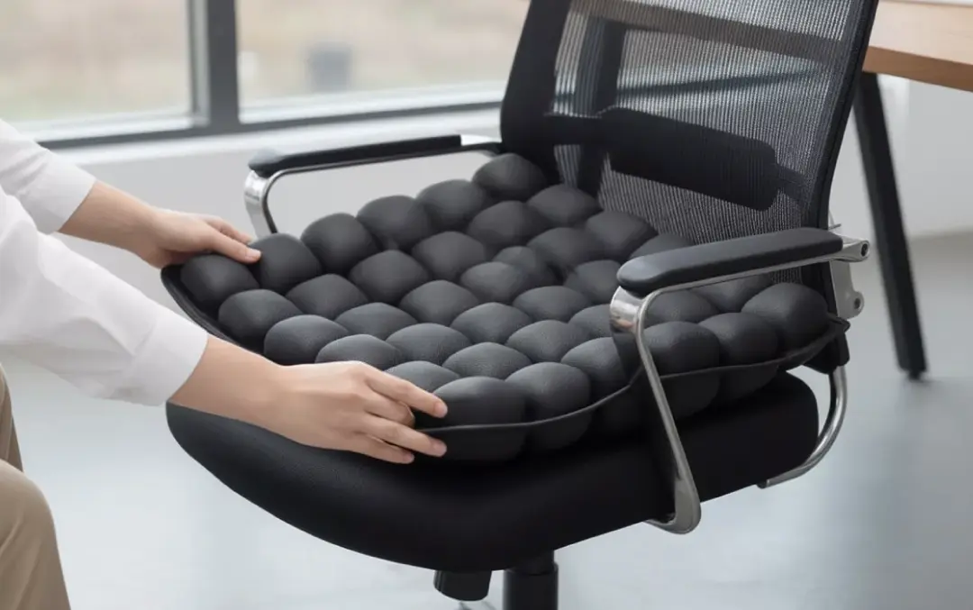 ErgoRestore cushion being placed on an office chair